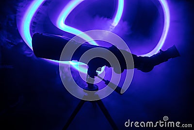 Silhouette of a astronomy telescope on dark foggy backlight Stock Photo