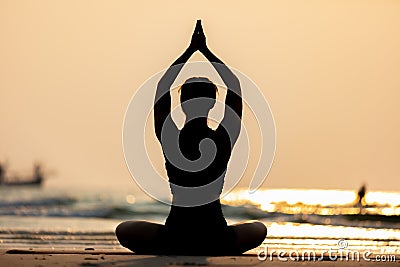 Silhouette Back of views woman practice yoga lotus pose to meditation with summer vacation on the beach Stock Photo