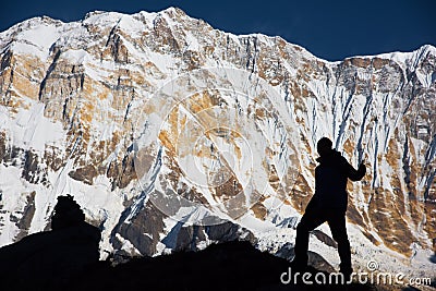 Silhouette backpacker on the rock and Annapurna I Background 8,091m from Annapurna Basecamp ,Nepal. Stock Photo