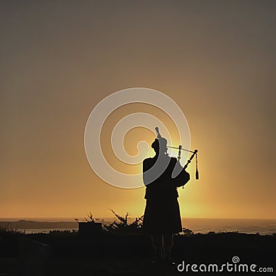 A silhouette of a bagpiper with the sun setting behind him and a view of the Pacific Ocean in Carmel, California Stock Photo