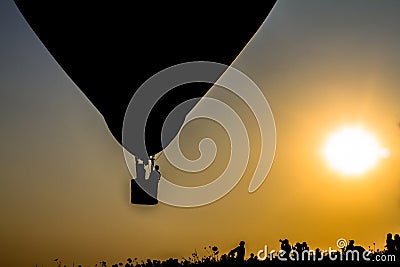 Silhouette balloon floating in the air with the light of the evening sun. Stock Photo