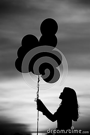 Silhouette balloon girl Stock Photo