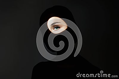 Silhouette of beautiful girl in the dark. young woman with light on the face Stock Photo