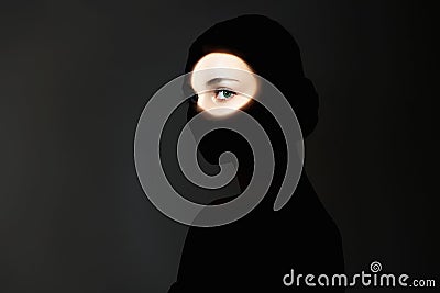 silhouette of beautiful girl in the dark. young woman with shadow on the face Stock Photo