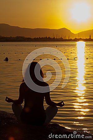 Silhouette of a beautiful woman excercising Yoga Stock Photo