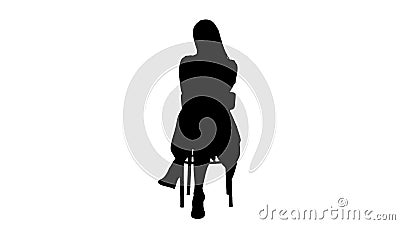 Silhouette Beautiful young woman, girl, model blonde with long hair sitting on a chair and looking to camera. Stock Photo