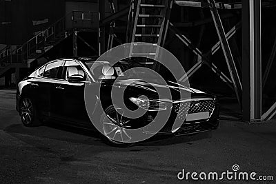 Silhouette of black sports car with headlights on black background Stock Photo