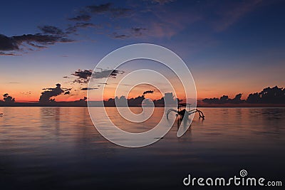 Silhouette of boat against the sunrise sky Stock Photo