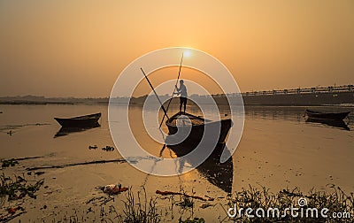 Silhouette boat with oarsman at sunset on river Damodar. Editorial Stock Photo
