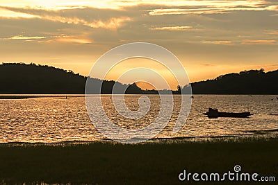 Silhouette of a boat in the water Stock Photo