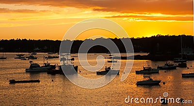 Silhouettes of boats at sunset Stock Photo