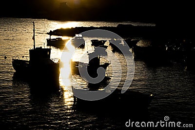 Silhouette Boats at Sunset Stock Photo