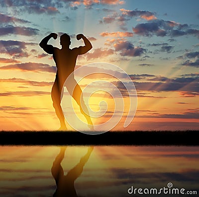 Silhouette of bodybuilder posing at sunset Stock Photo