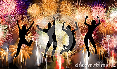 Silhouette of boy and girl jumping happy enjoy brightly colorful fireworks Stock Photo