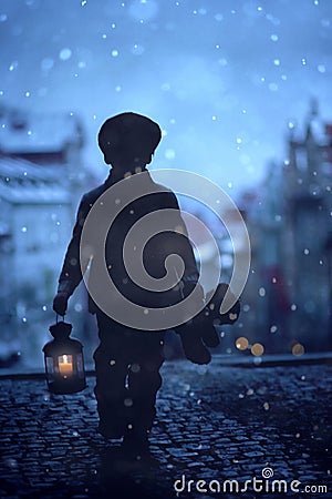 Silhouette of boy, standing on stairs, holding lantern and teddy Stock Photo