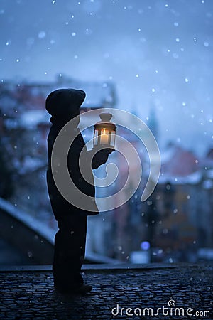 Silhouette of boy, standing on stairs, holding lantern, view of Stock Photo