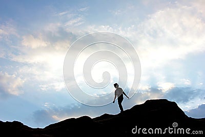 Silhouette of a boy on top of mountain at sunset. Editorial Stock Photo