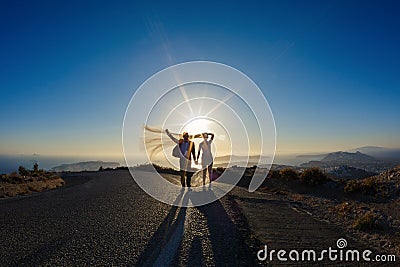 Silhouette of the bride and groom on the road Stock Photo