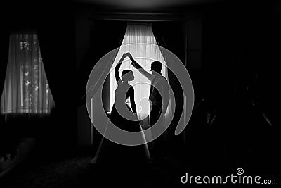 Silhouette of bride and groom by the window Stock Photo