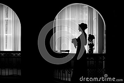 Silhouette of a bride at the window Stock Photo