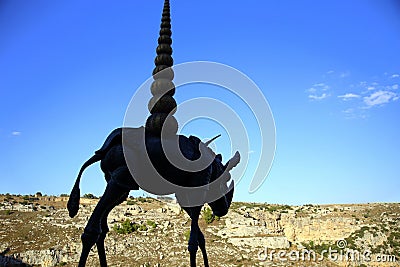 Silhouette of the bronze structure against the view of the arid Murgia of Matera, European Capital of Culture 2019 Editorial Stock Photo