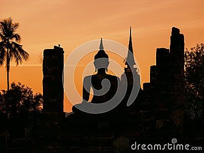 Silhouette Buddha Pagoda landscape sunset at Sukhothai Historical Park Stock Photo