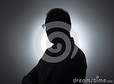 Silhouette of businessman. Male shadow on backlit. Profile of black man in eyeglasses Stock Photo