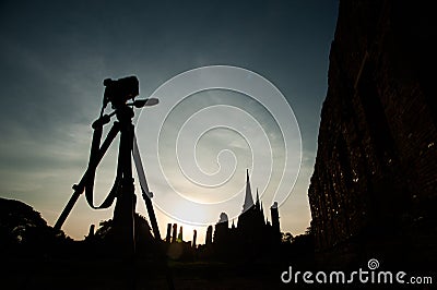 Silhouette of camera on tripod and three pagoda of Wat Phra Sri Sanphet Stock Photo