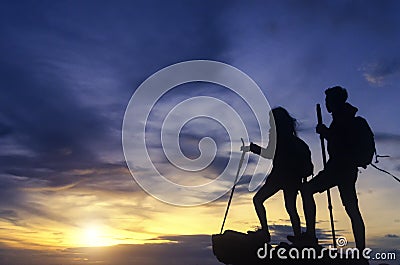 Silhouette of a champion couple on the top of a rock mountain vi Stock Photo