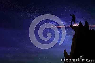 Silhouette of a champion man and the Universe.A person is standing on the top of the hill next to the Milky Way galaxy with Stock Photo