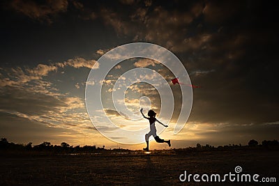 Silhouette of children flying a kite on sunset Editorial Stock Photo