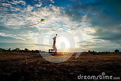 Silhouette of children flying a kite on sunset Editorial Stock Photo