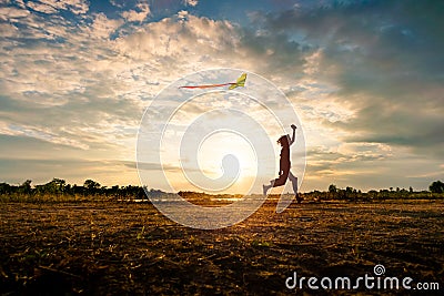 Silhouette of children flying a kite on sunset Editorial Stock Photo