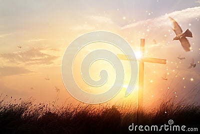 Silhouette christian cross on grass in sunrise background Stock Photo