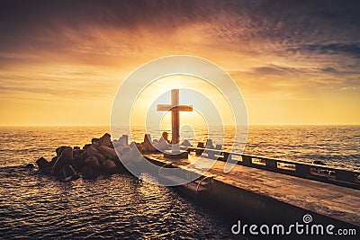 Silhouette christian cross in the sea, sunrise shot Stock Photo