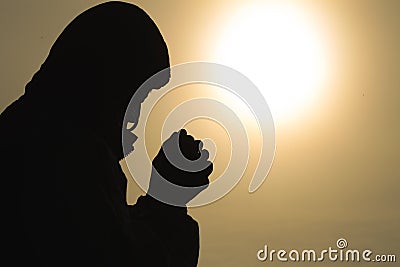 Silhouette of christian man hands praying to god, Man Pray for god blessing to wishing have a better life. begging for forgiveness Stock Photo