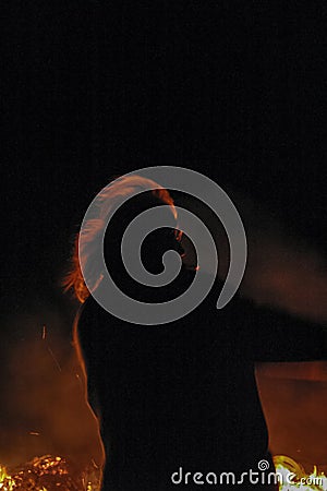 Silhouette of a civil war re enactor lit by a campfire Editorial Stock Photo