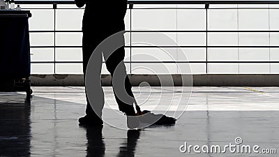 Silhouette of cleaning service people sweeping floor Stock Photo