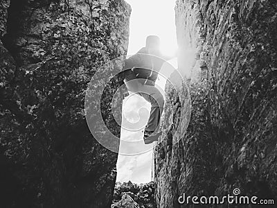Silhouette of climber in crevasse in black and white Stock Photo