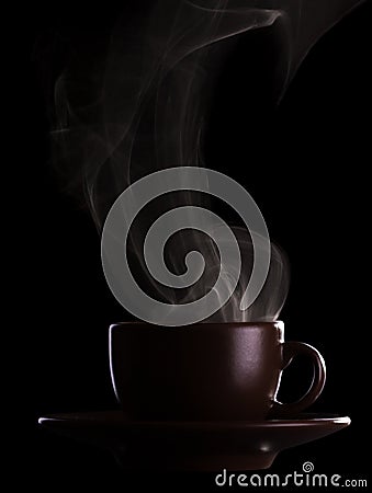 Silhouette coffee cups with saucer and hot steam isolated on black Stock Photo