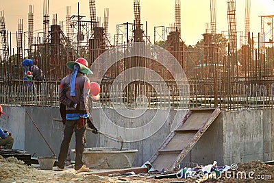 Silhouette construction industry of Engineer Business Concept with worker standing and mix Cement,steel rod Editorial Stock Photo