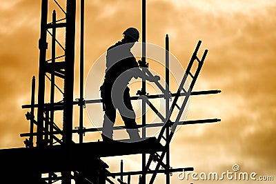 Silhouette construction worker on scaffolding building site Stock Photo