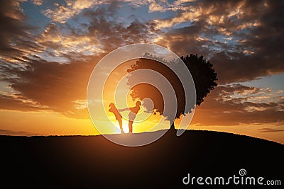 Silhouette of a couple in abstract field with heart shape tree with sunset.Romance and Valentine concept background. Stock Photo