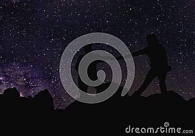 Silhouette of couple holding hands beneath the stars, Milky Way and a lot of stars over the mountain at Wadi Rum desert. Stock Photo