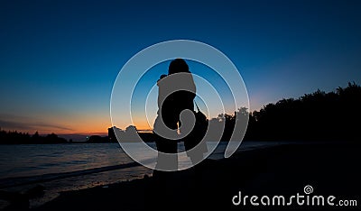 Silhouette of couple hug on the Beach after sunset Stock Photo