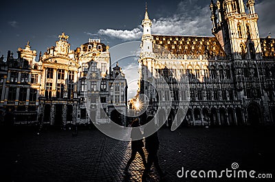 Silhouette couple walking on the square under the Grand Palace during sunrise Editorial Stock Photo