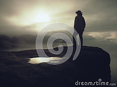 Silhouette of a cow girl or cowboy stay on edge and watching Stock Photo