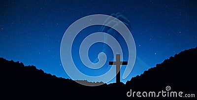 Silhouette of crucifix cross on mountain at night time with hand praying background. Stock Photo