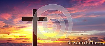 Silhouette of crucifix cross at sunset sky. Stock Photo