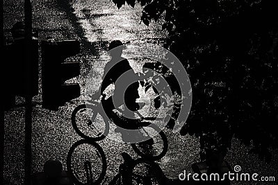 Silhouette of a Cyclist in the Rain Stock Photo